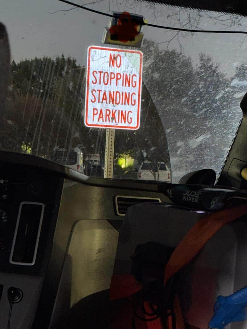 No stopping standing parking sign seen from inside a vehicle.