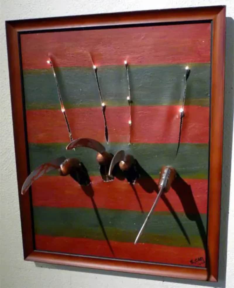 Knives and forks with LED lights on a colorful striped background.