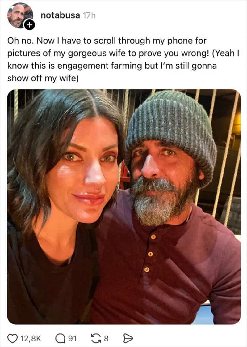 A woman and a man taking a selfie, woman has dark hair, man has a beard and wears a gray beanie.