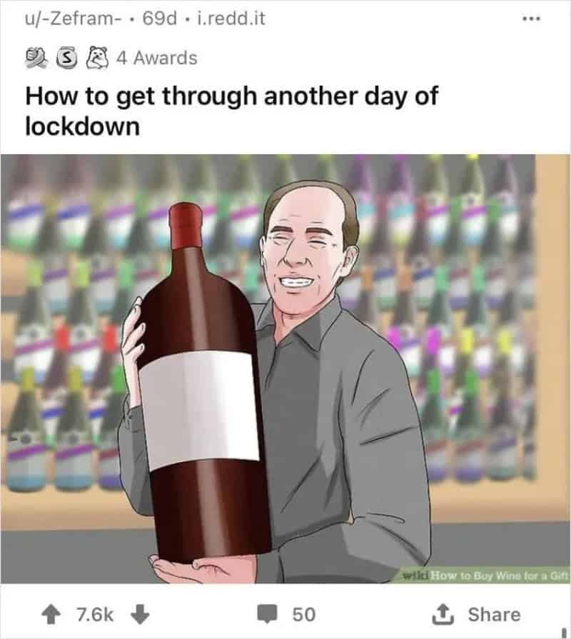 Person holding a large wine bottle with a blank label, smiling.