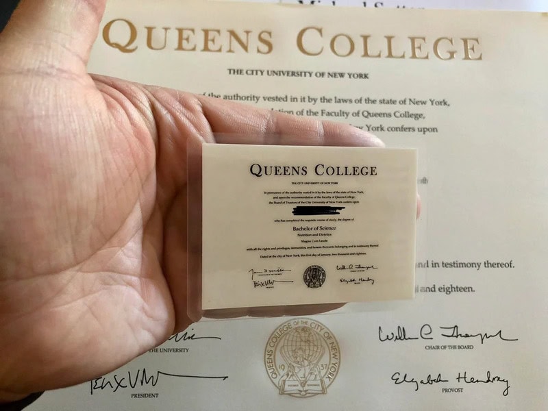 Hand holding a Queens College ID card in front of a document.