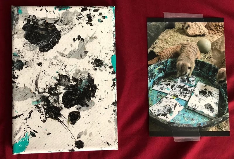 Abstract black and white paint splatters on canvas with teal accents.