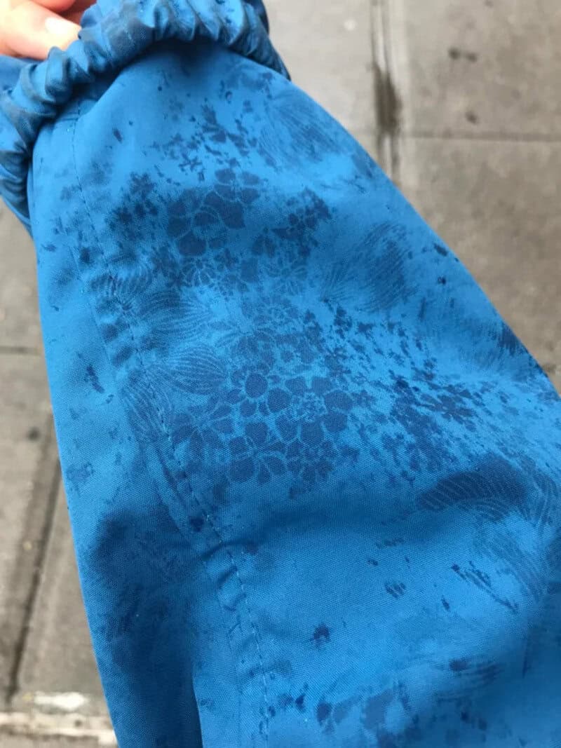 Close-up of blue fabric with floral pattern and water-resistant coating.