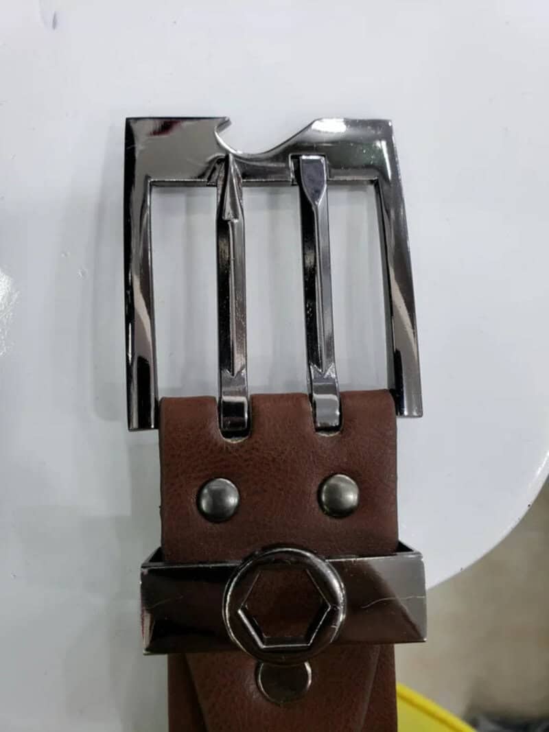 Belt with a buckle that doubles as a bottle opener.
