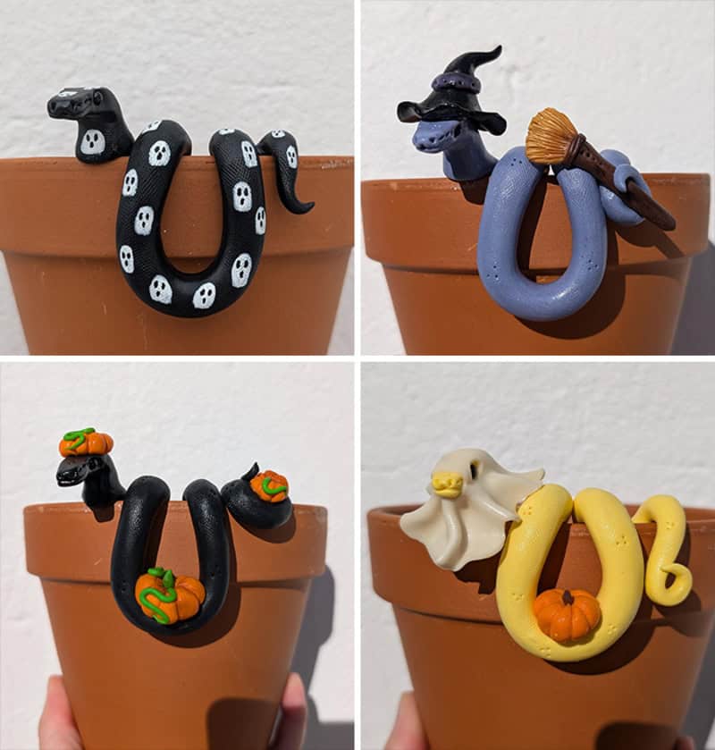 Four miniature clay snakes in small terracotta pots themed for Halloween; each snake is perched on a.