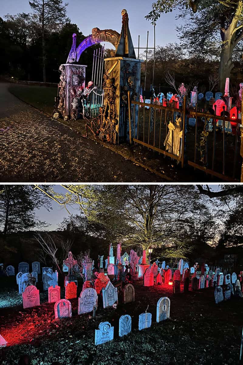 Halloween cemetery display with illuminated fencing, tombstones, and spooky archway at dusk.
