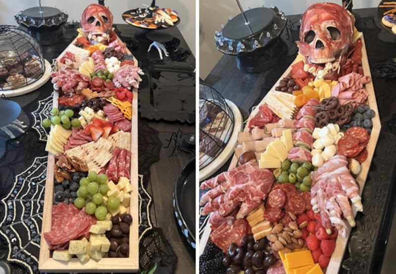 Charcuterie board with cheese, fruit, meats, nuts and a pink skull centerpiece for Halloween.