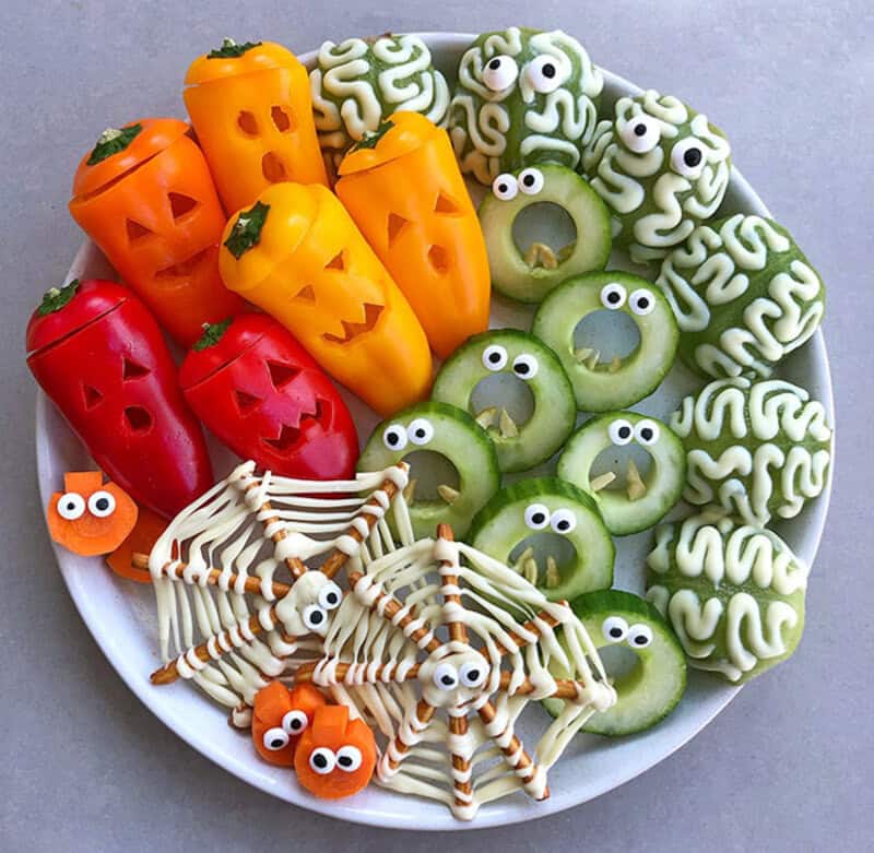 Halloween veggie platter with carved pepper jack-o'-lanterns, green melon brains, cucumber rings, dr.