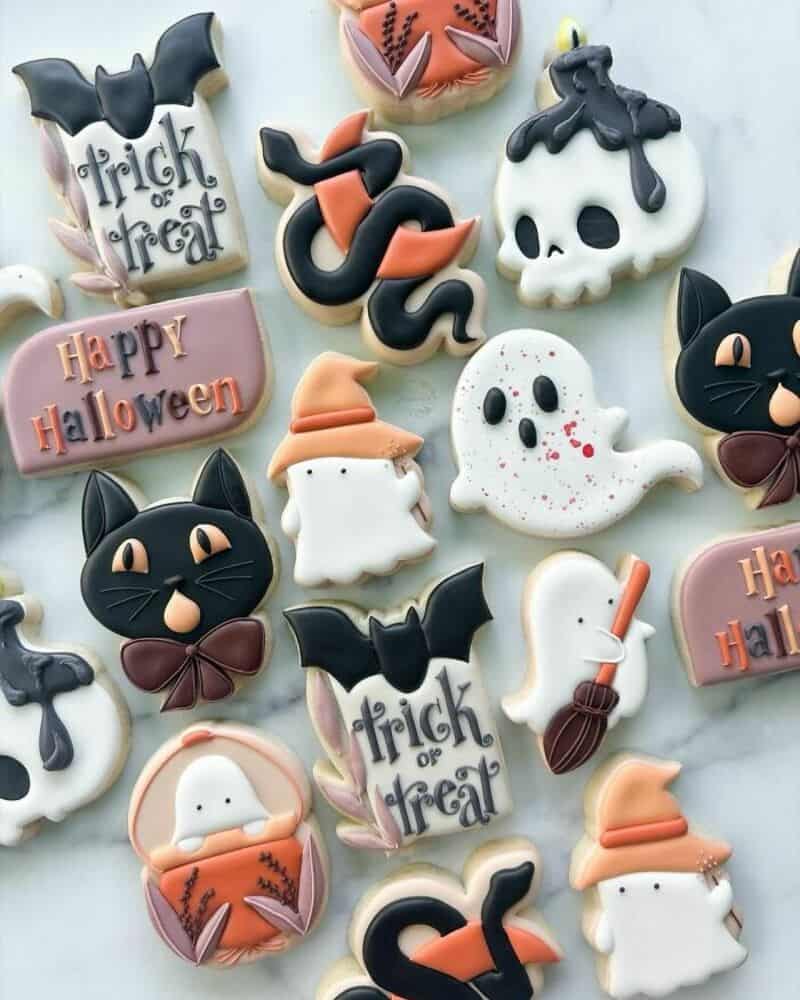 Trick or treat Halloween cookies with ghosts, bats, pumpkins and moons on colorful icing.