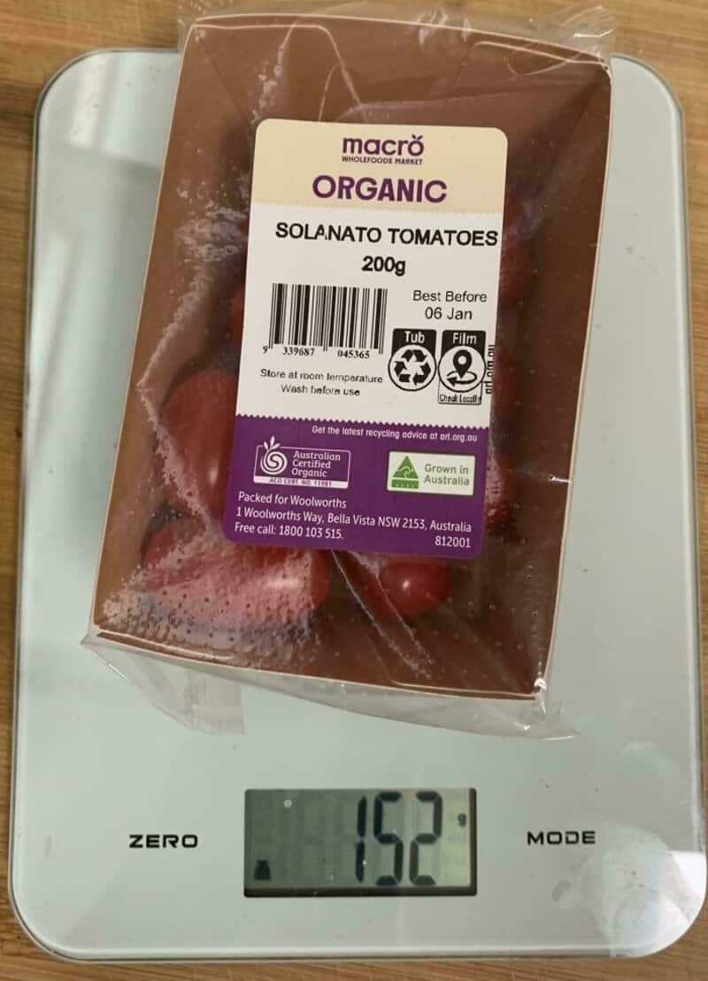 Organic Solanato Tomatoes 200g in plastic packaging on scale.