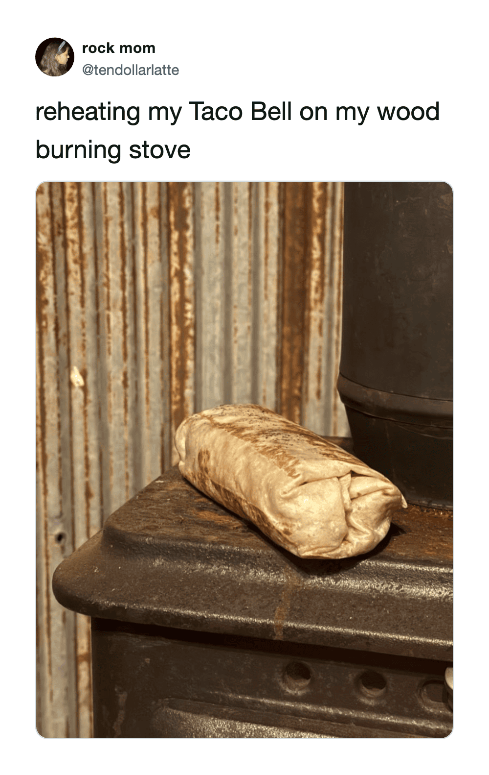 Reheating Taco Bell on a wood burning stove with a burrito on top.