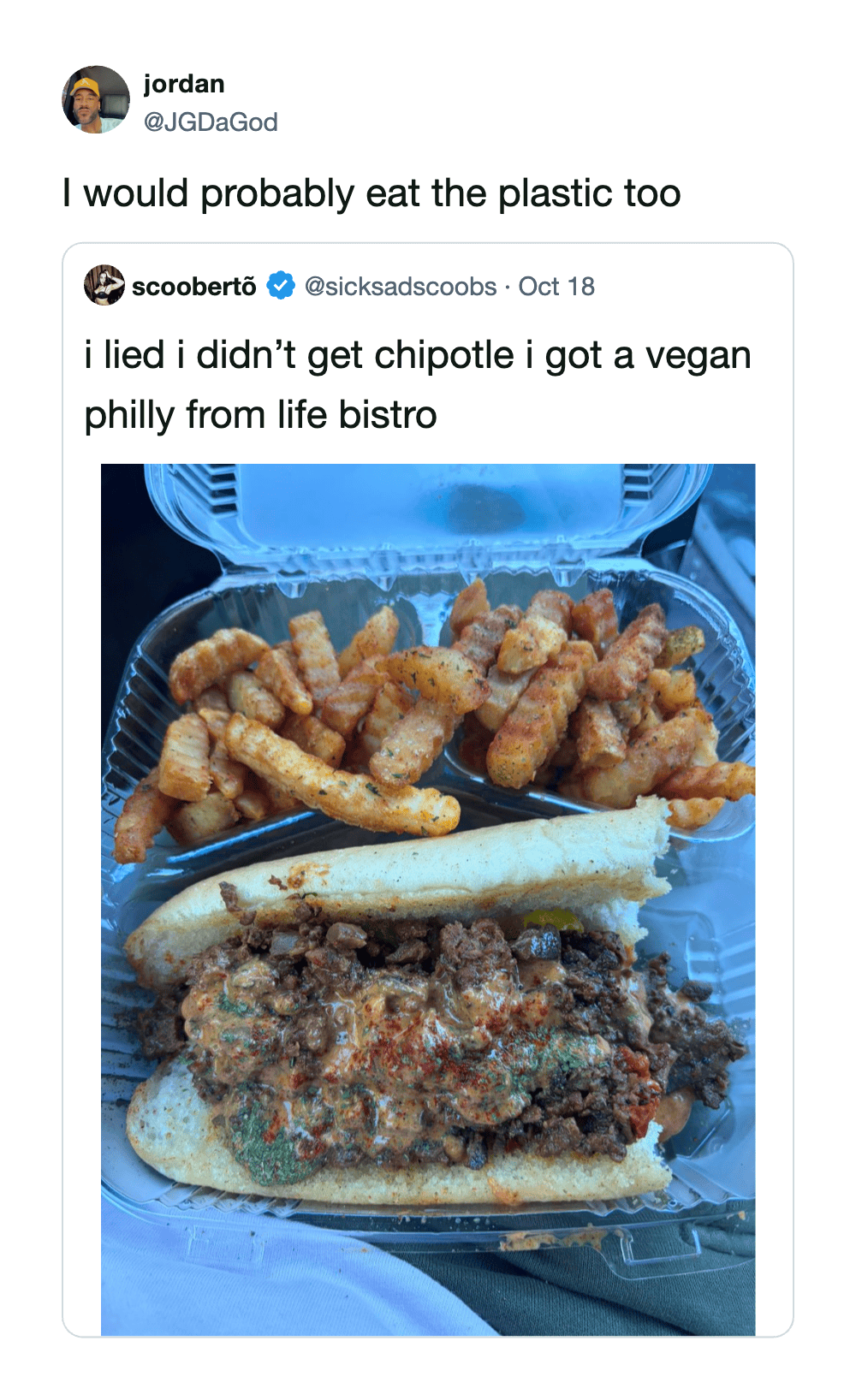 Vegan Philly cheesesteak with fries and curly fries in a takeout container.