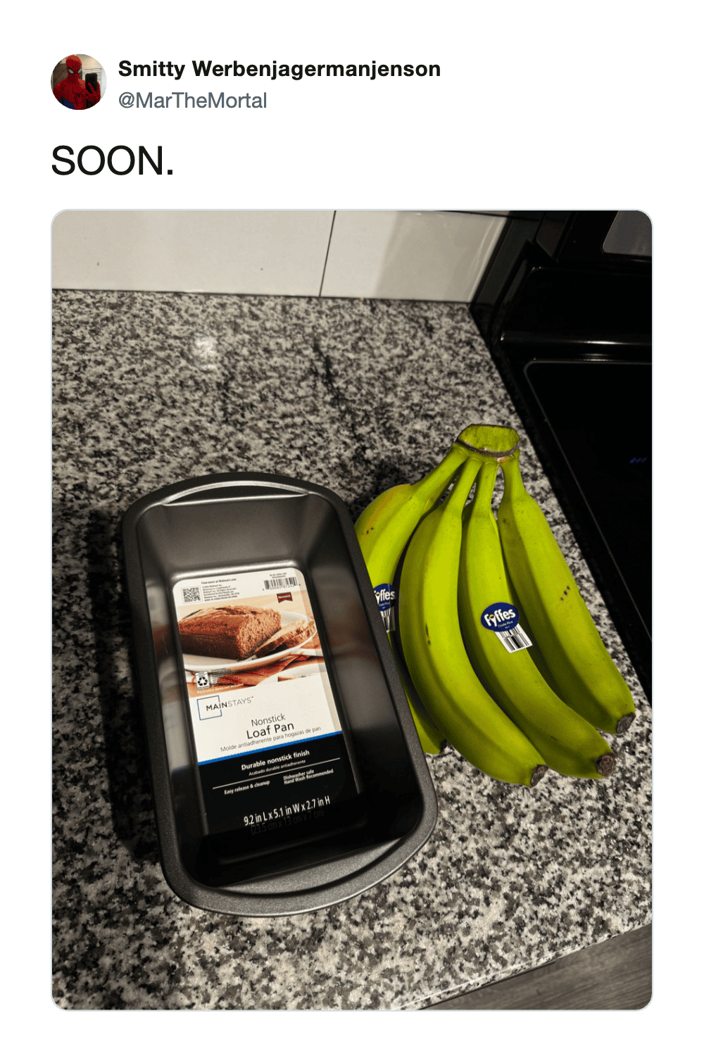 Grocery store checkout with bananas and a payment terminal on a granite countertop.