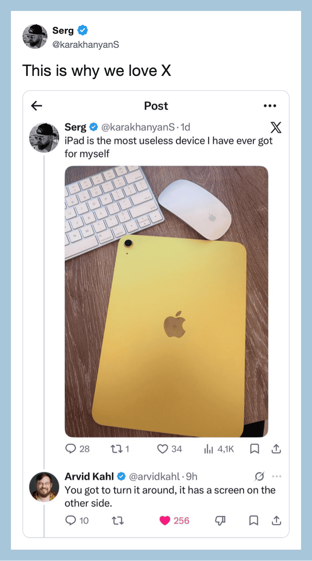 IPad with yellow back, keyboard, and mouse on wooden surface.