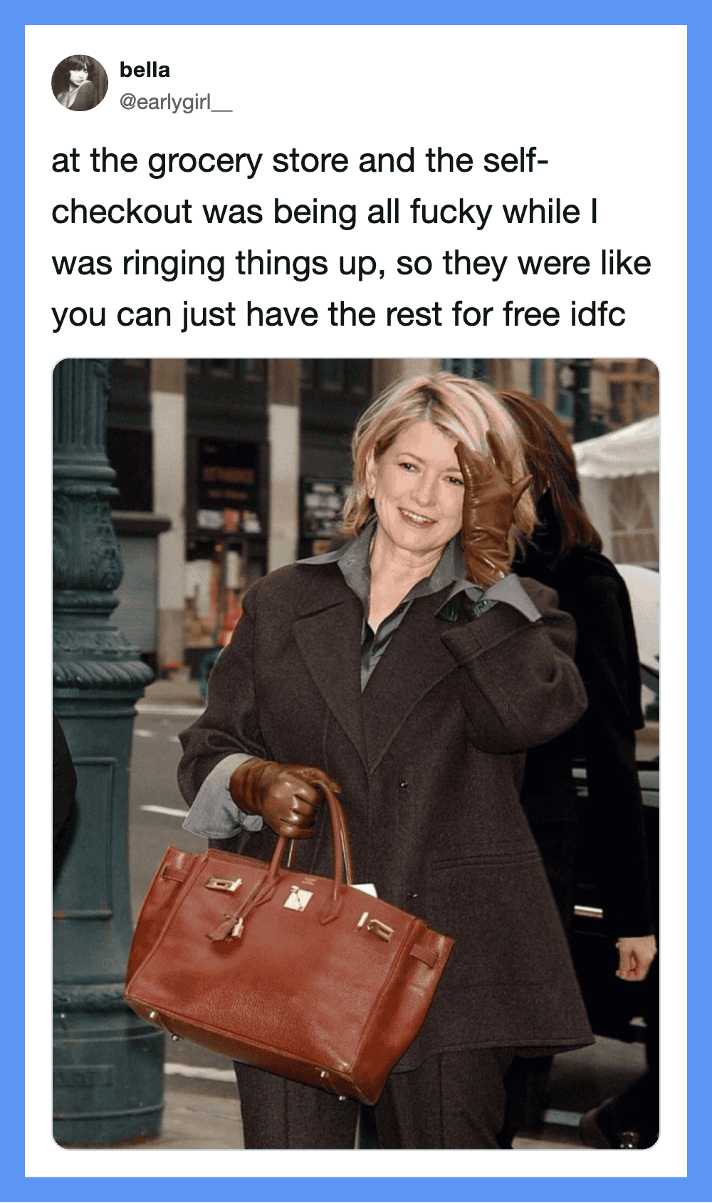 Woman with brown hair in a coat holding a large brown handbag on a city street.