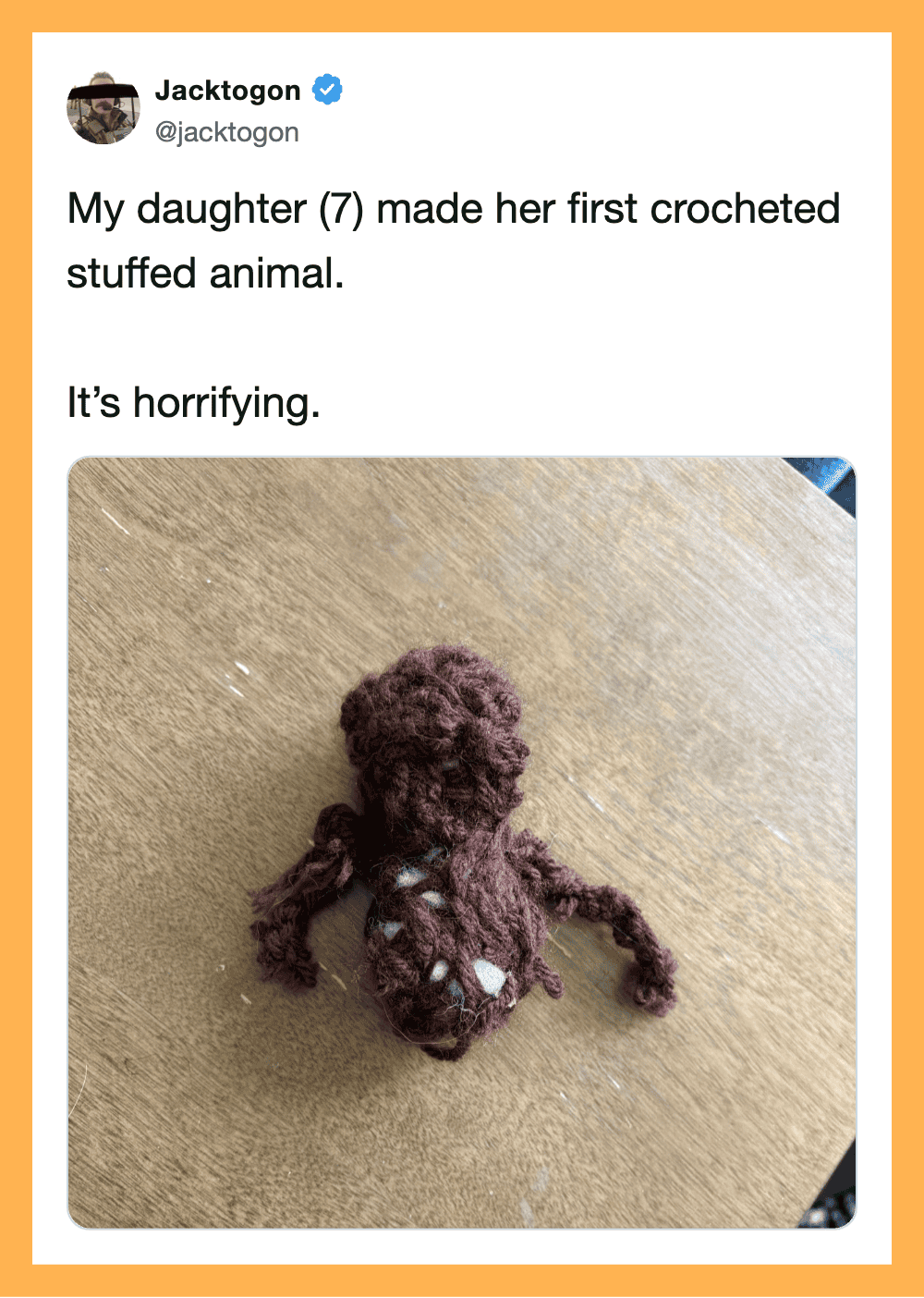 A crocheted stuffed animal resembling an octopus on a wooden surface.