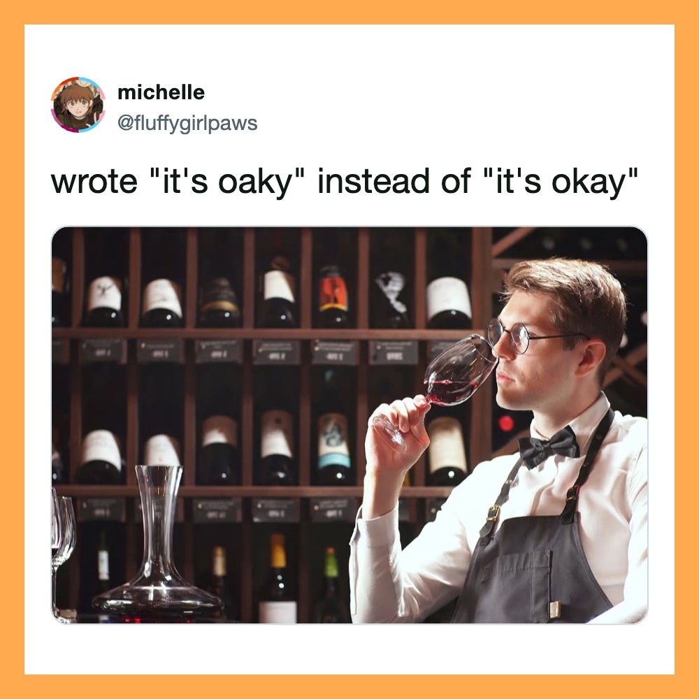 Man tasting wine in a wine cellar, wearing glasses and apron.