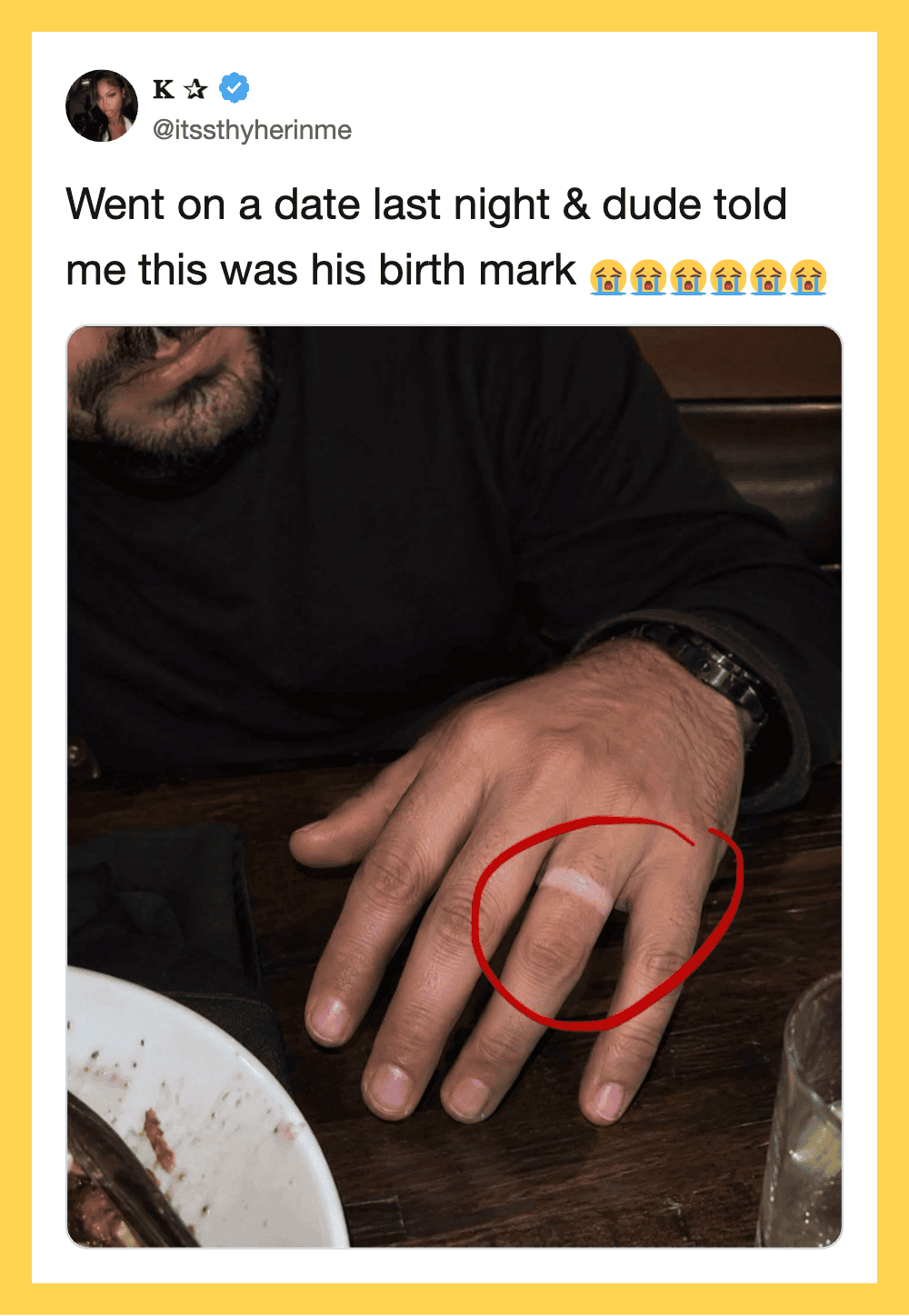 Man's hand with a ring, circled in red, on a table with food and drink.