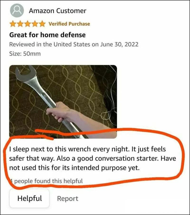 Person holding a wrench with a humorous review about sleeping next to it.