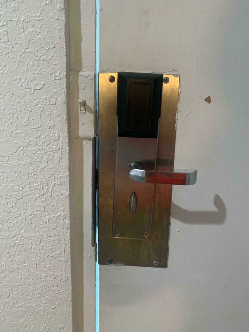 Door handle with a card reader and a metal plate, no visible lock or keyhole.