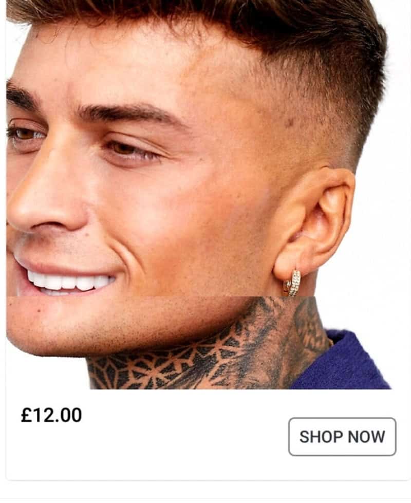 Smiling man with tattooed neck and earring, close-up profile.