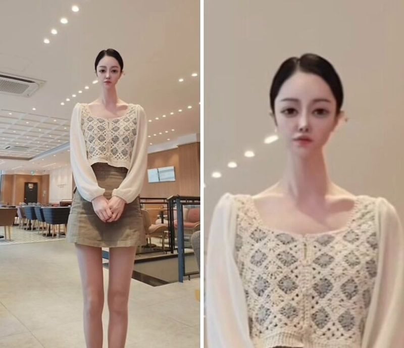 Woman standing in a modern indoor setting wearing a lace top and beige skirt.