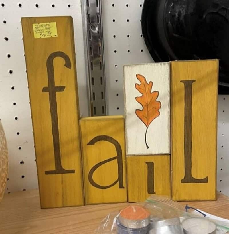 Wooden blocks spell 'fall' with a leaf illustration on one block.