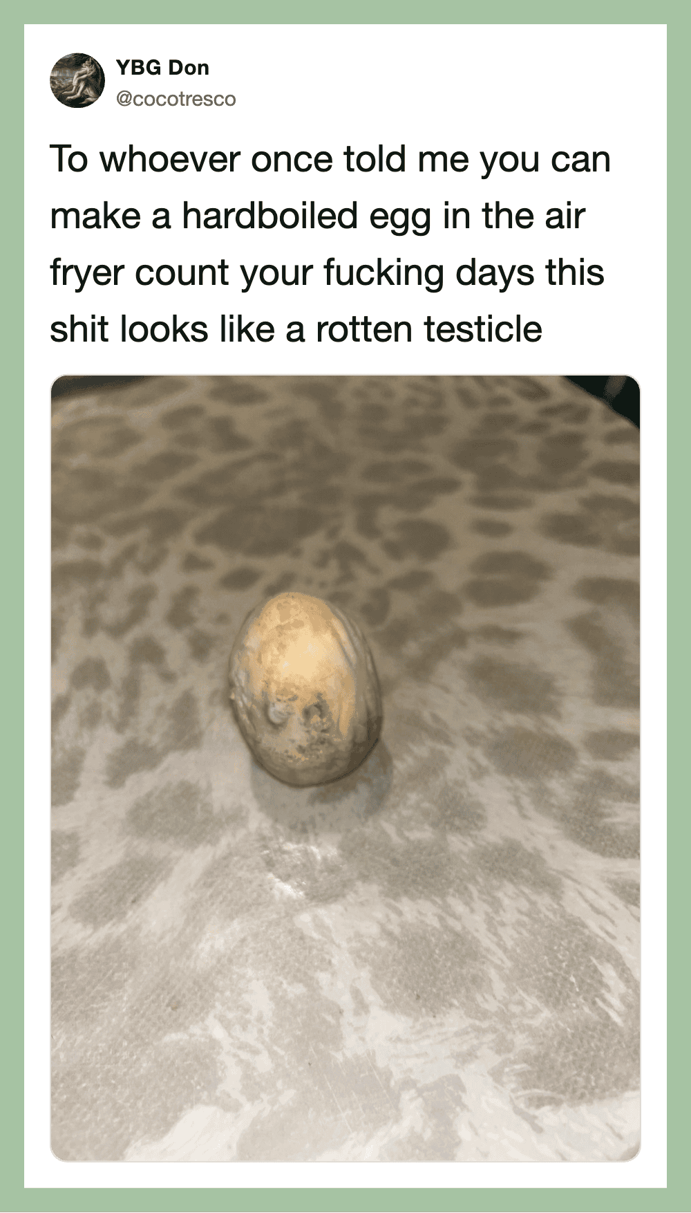 Hardboiled egg in air fryer on a patterned surface with humorous caption.