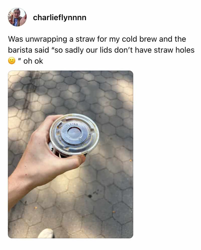 Hand holding a cold brew can with no straw holes, on a hexagonal tiled ground.