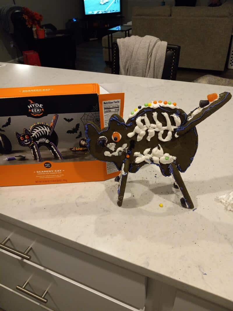 Halloween skeleton horse cake with black body and colorful decorations.