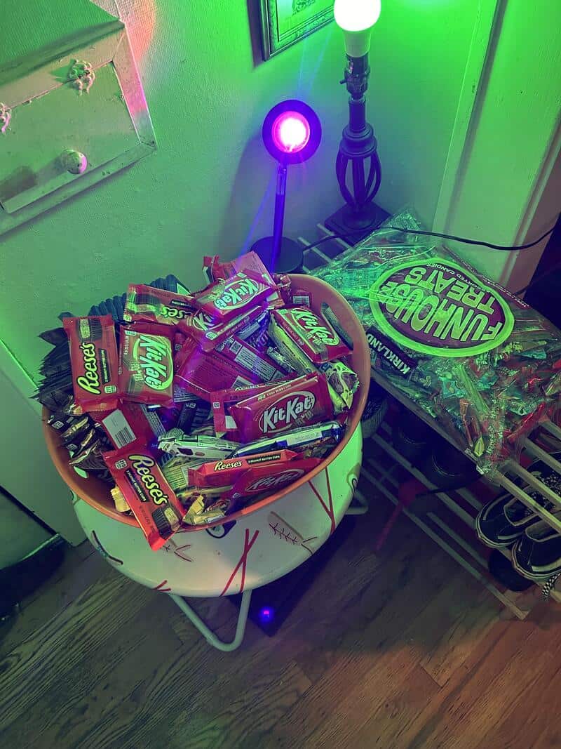 Colorful Halloween scene with candy and glowing lights in a room.