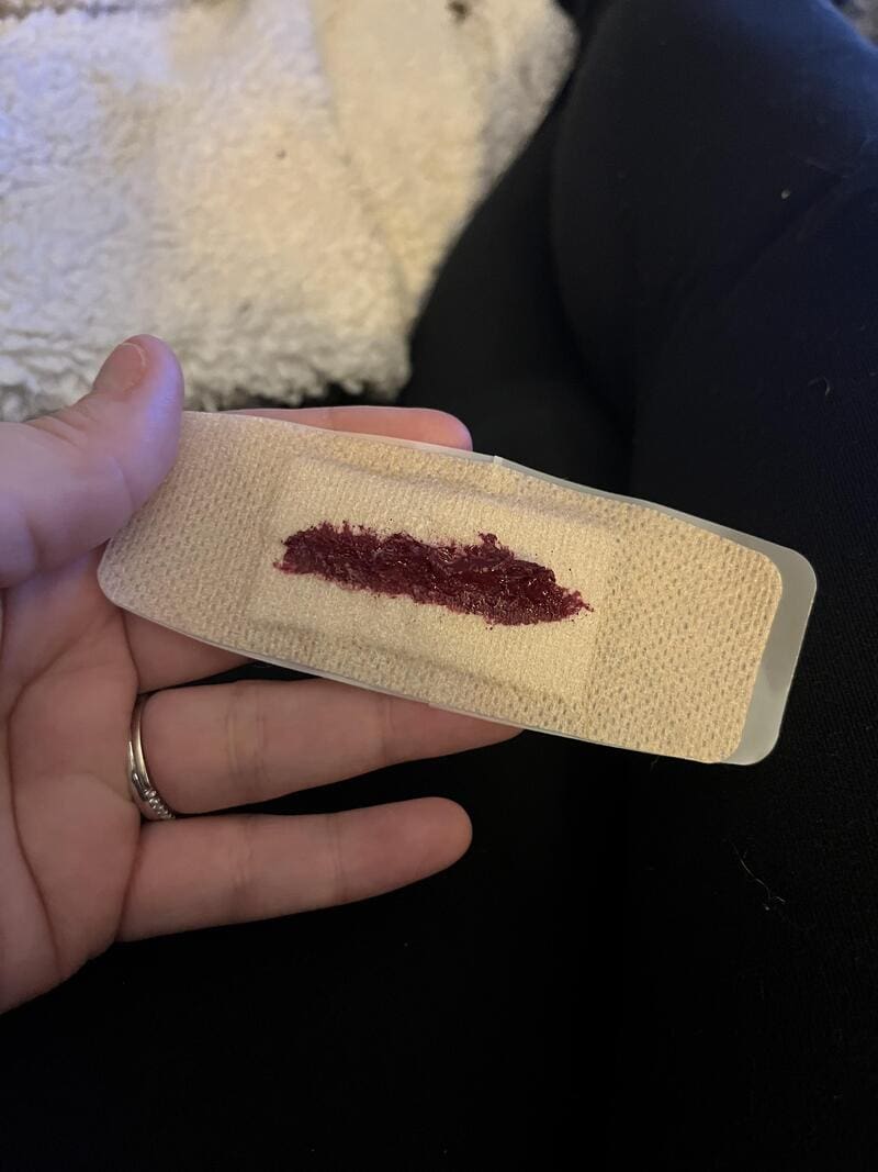 A bandage with a fake blood stain, part of a Halloween fail.