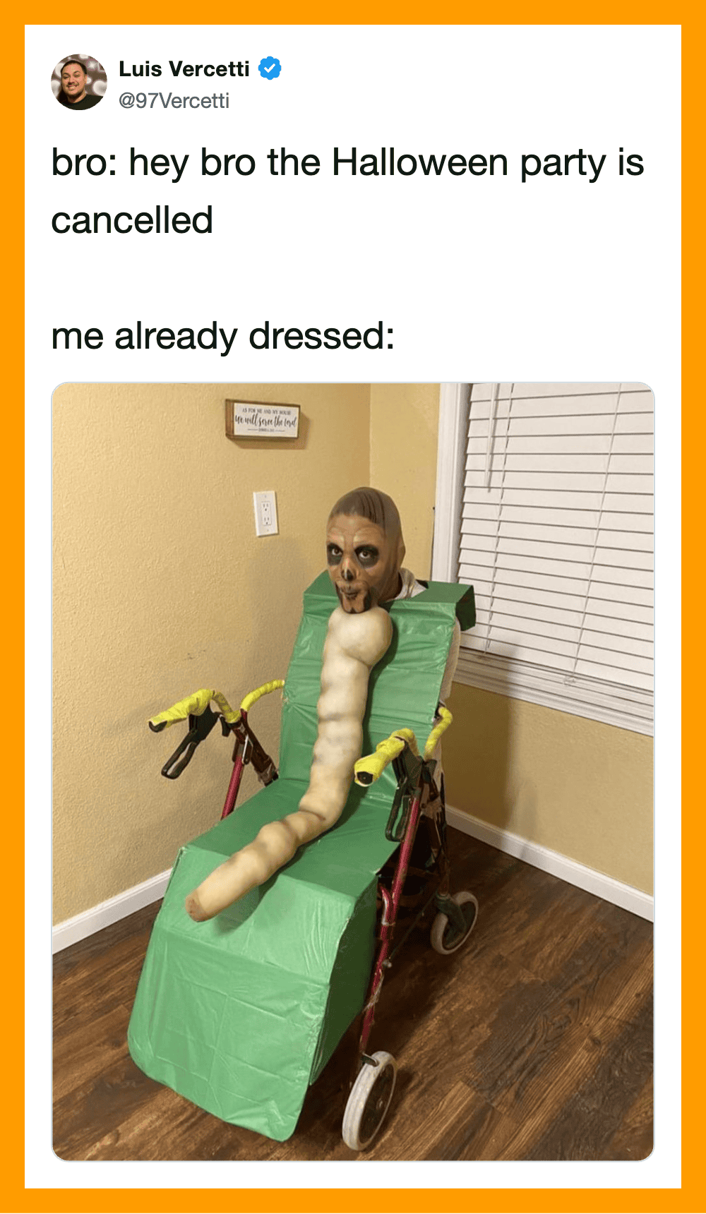 Person in a homemade Halloween costume with a face mask and a long, worm-like body on a green cart.
