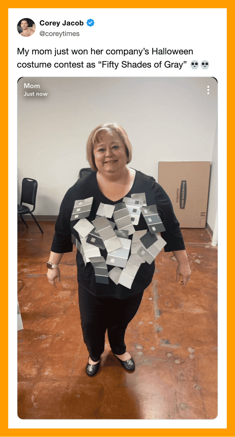 Woman in Halloween costume with gray boxes around her neck, smiling.