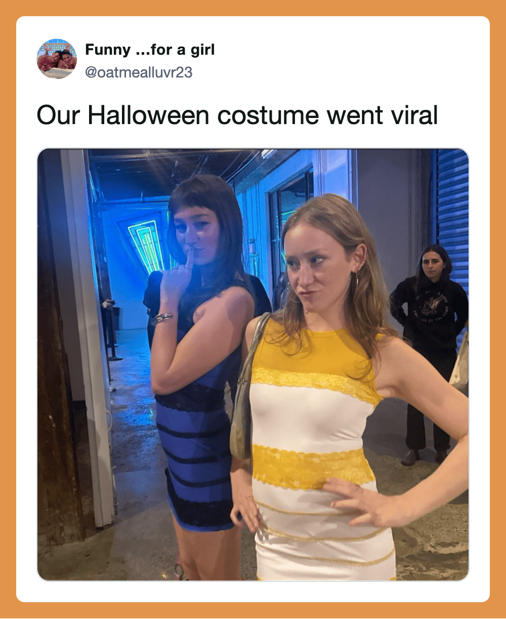 Two women in costume posing, one in a blue striped dress, the other in a white and yellow dress, in.