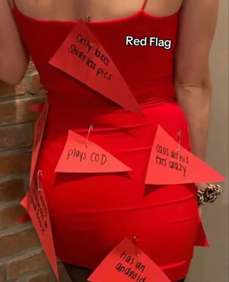 Red dress with orange notes attached listing humorous Halloween facts.