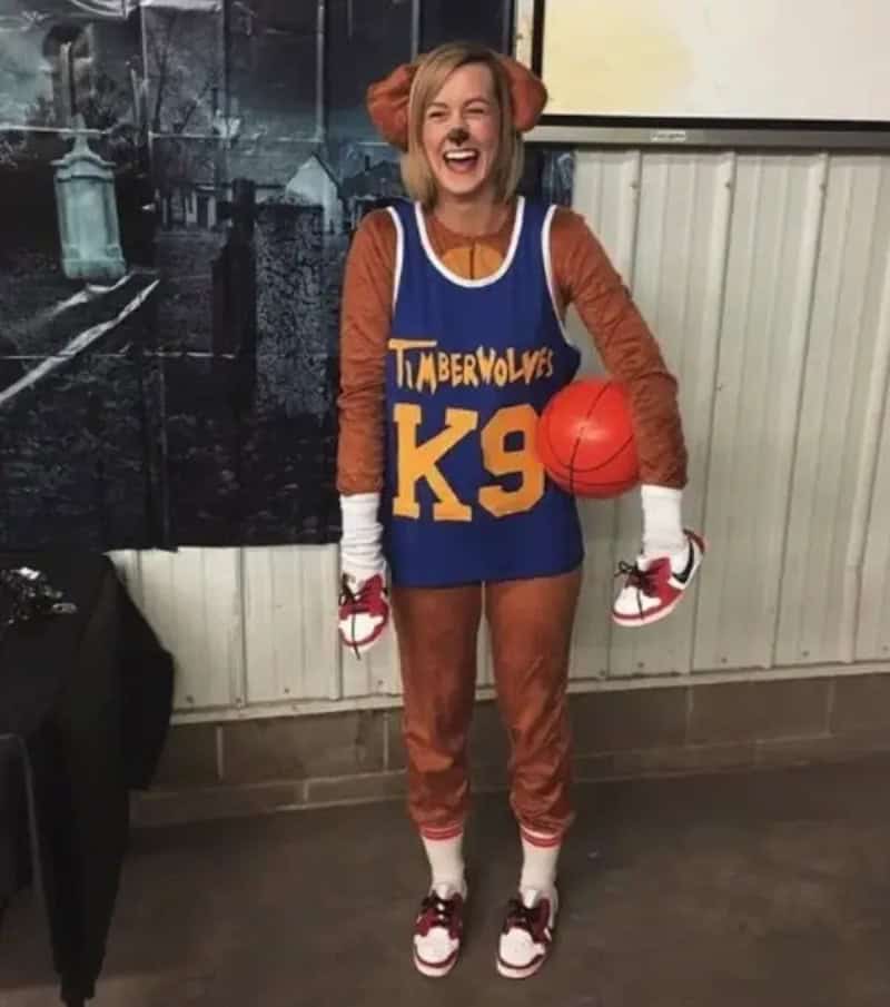 Girl dressed in Timberwolves K9 basketball costume, orange ears, blue jersey, holding orange ball, 3.