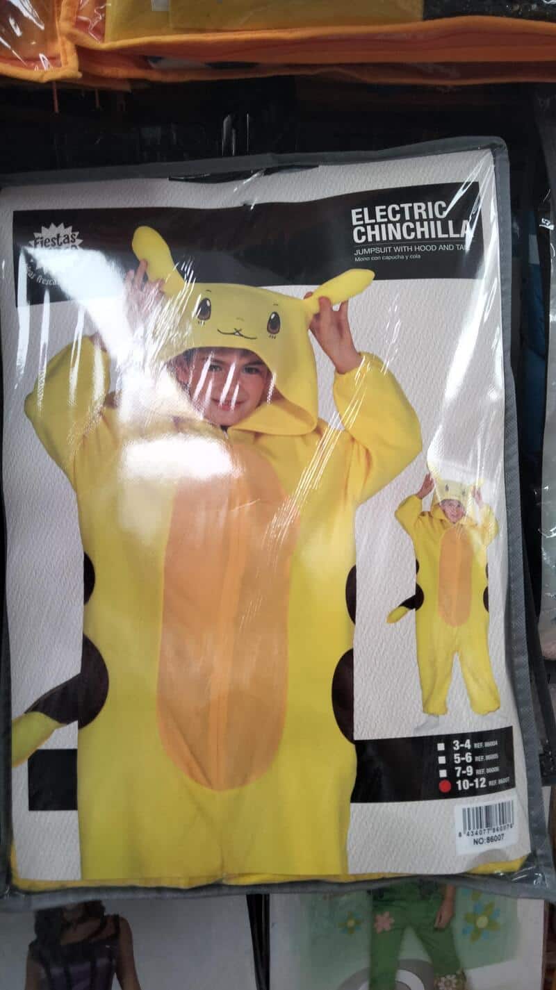 Child in Pikachu costume with hood and tail, holding the hood's ears.