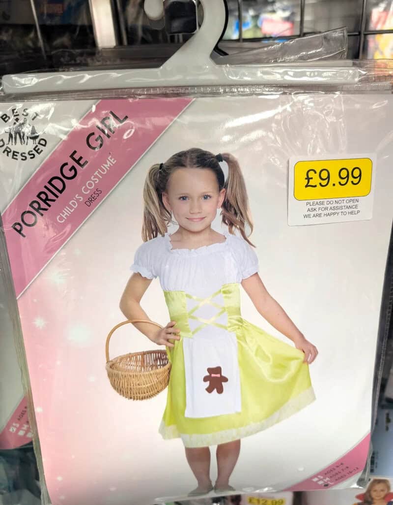 Child dressed as a gingerbread girl in a costume with a basket, priced at £9.99.