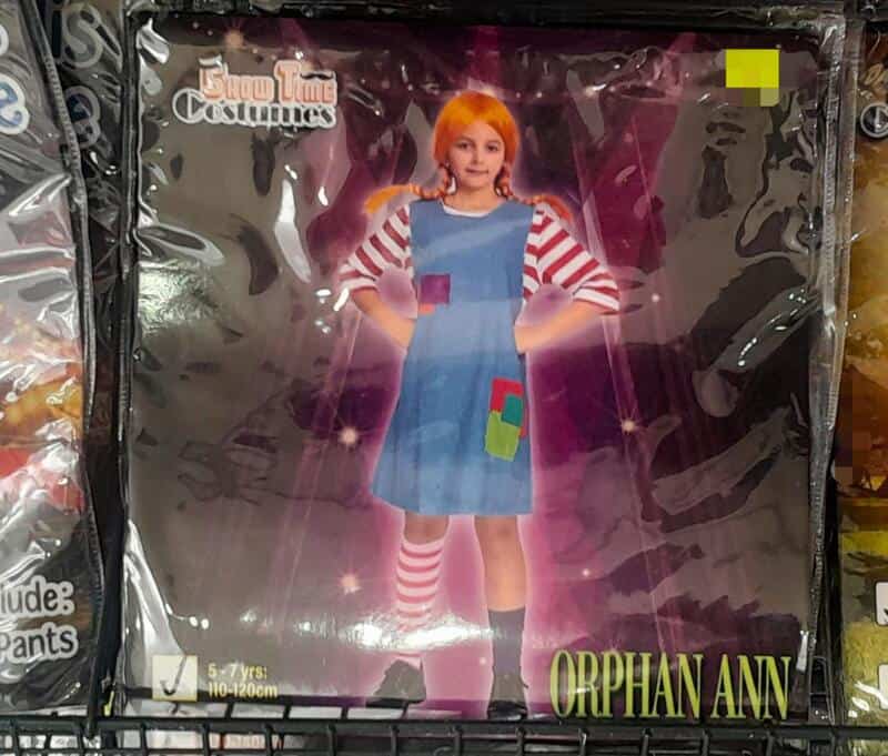 Child's costume of a girl with orange hair, striped shirt, and patchwork dress.