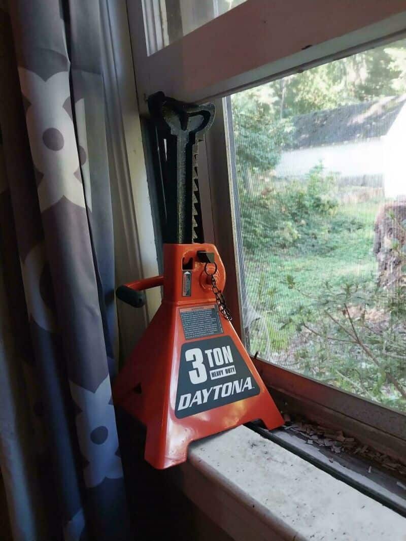 3-ton Dayton hydraulic jack on windowsill with trees outside.