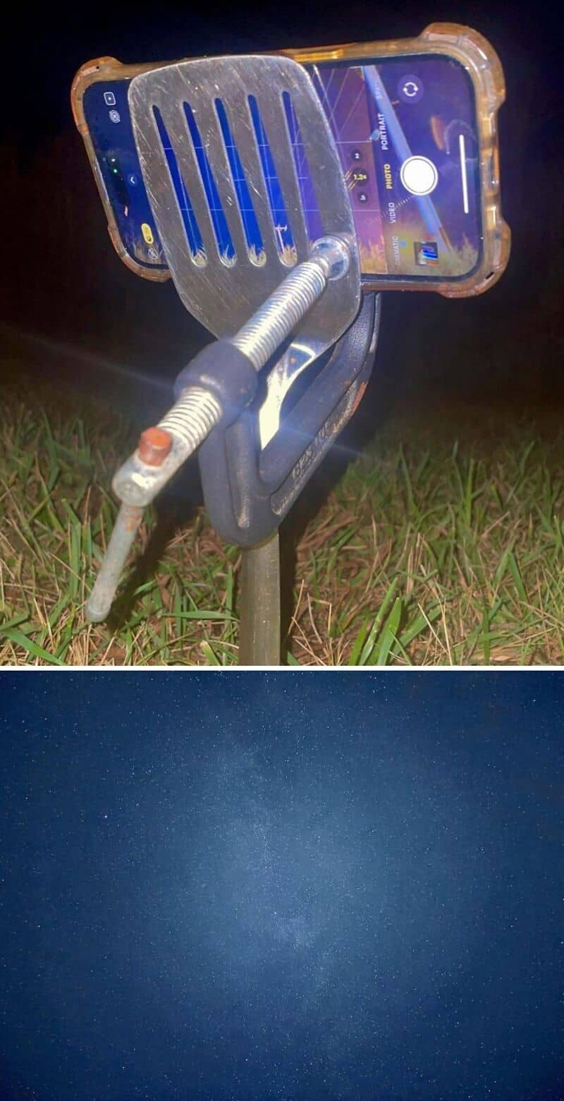 Phone mounted on a homemade stand with a slotted metal plate, outdoors at night.
