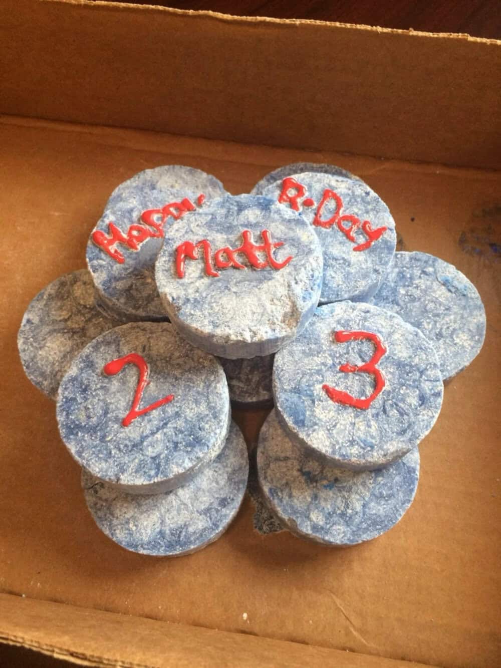 Stack of blue cupcakes with red writing for Mother's Day and numbers 1, 2, 3.