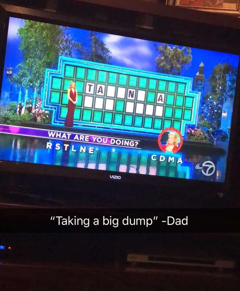 Family feud game show with a woman and a man on stage, puzzle board with T A N A, and a caption '"TA.