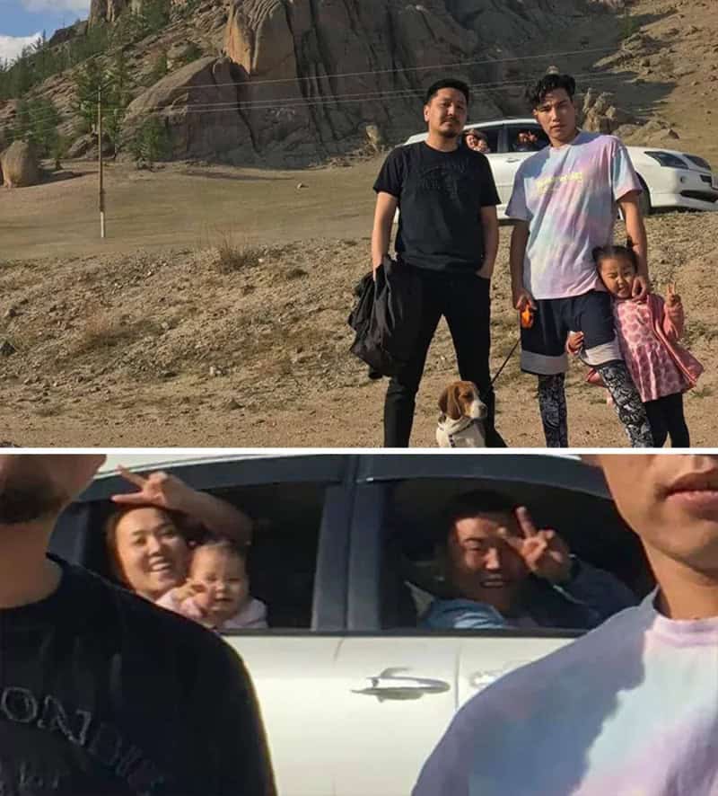 Group of people and children outside near a car with mountains in the background.