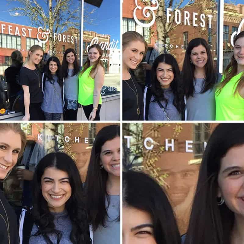 Group of young women taking a photo outside a cafe with a 'KITCHEN & FOREST' sign.