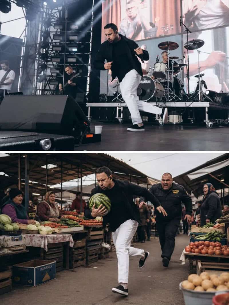 Man running with watermelon at outdoor market, band performing on stage in background.