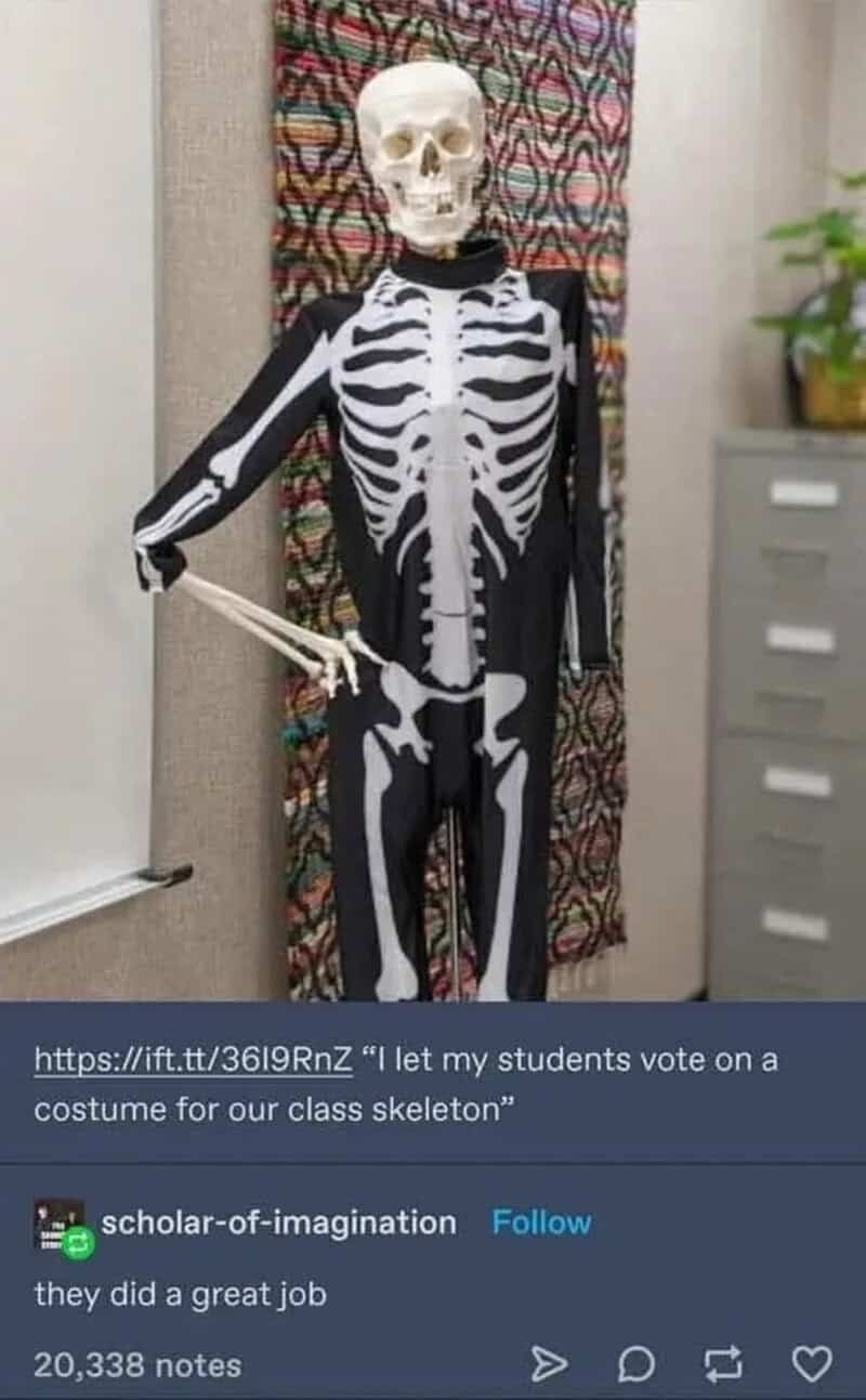 Child in skeleton costume holding a plastic sword in a classroom.