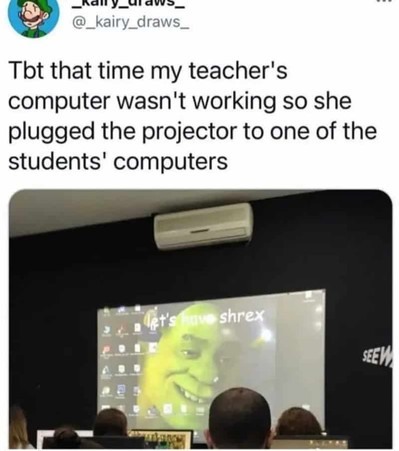Teacher's projector displays a funny face with the text "let's have shrex" during a class.