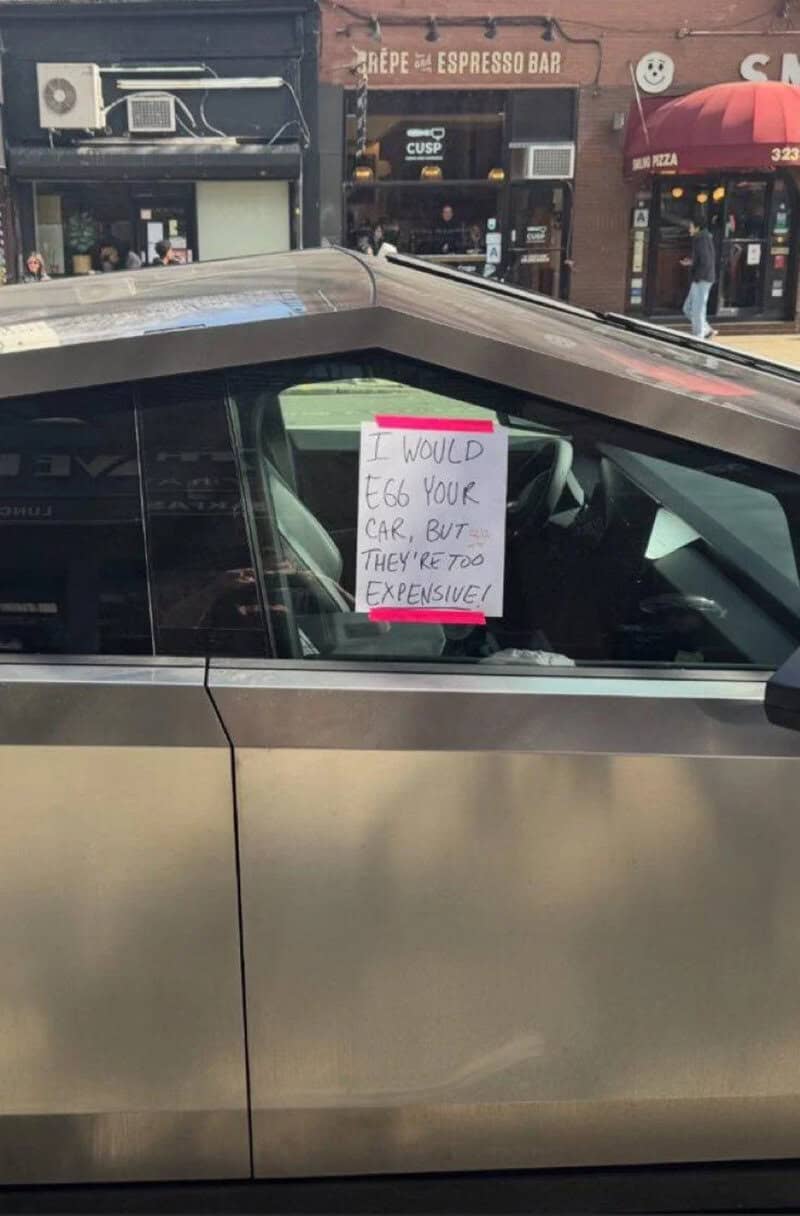 Sign on car window says, 'I would egg your car, but they're too expensive!'.